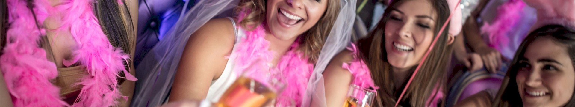 Four girls dressed in pink in a nightlcub.