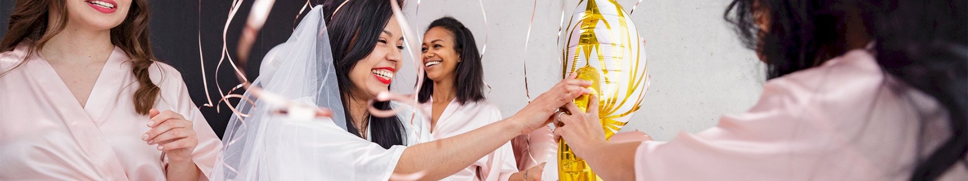Seven girls surrouned by balloons on a hen weekend.