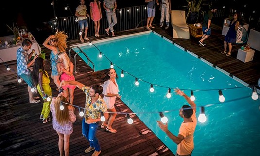 A group of people enjoying a pool party.