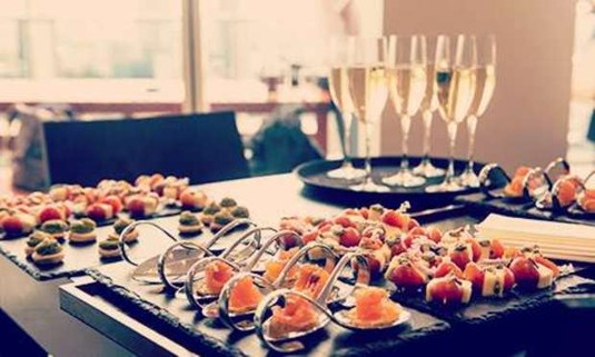 Plates of canapes with flutes of champagne. Discover Bristol Wine and Canapes on your hen night: