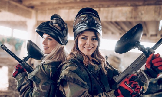 Two girls kitted up ready for paintballing