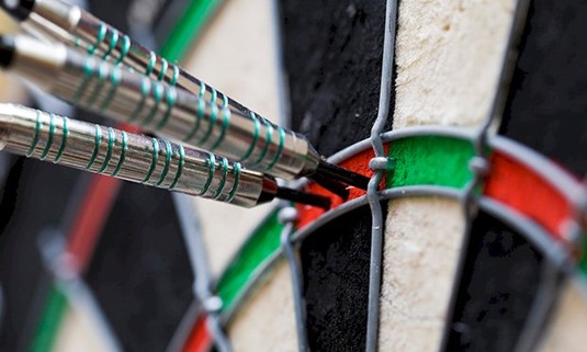 Three darts in a darts board.