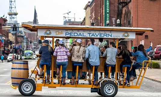 Ten ladies enjoying beer on a joint bike