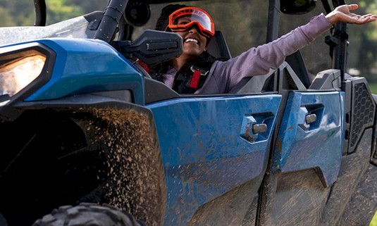 A lady in a 4x4 buggy driving.