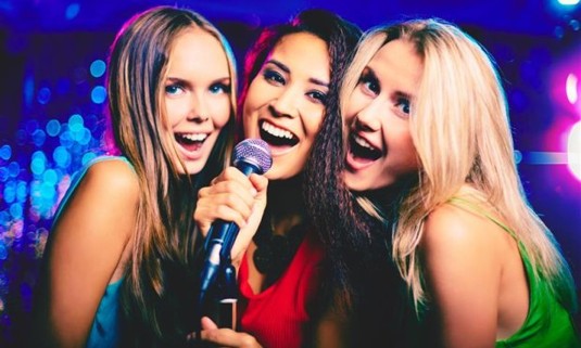 A group of girls enjoying a karaoke session as a part of a hen party