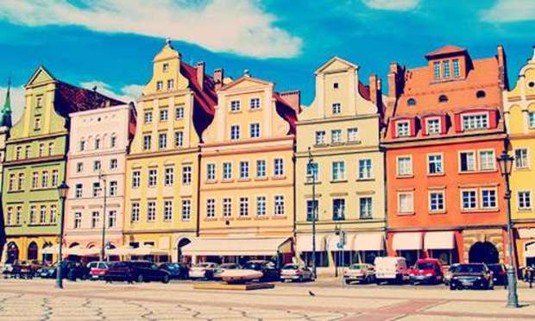 Old Town Square in Wroclaw lined with buildings in various colours. Explore Wroclaw Hen Party ideas below: